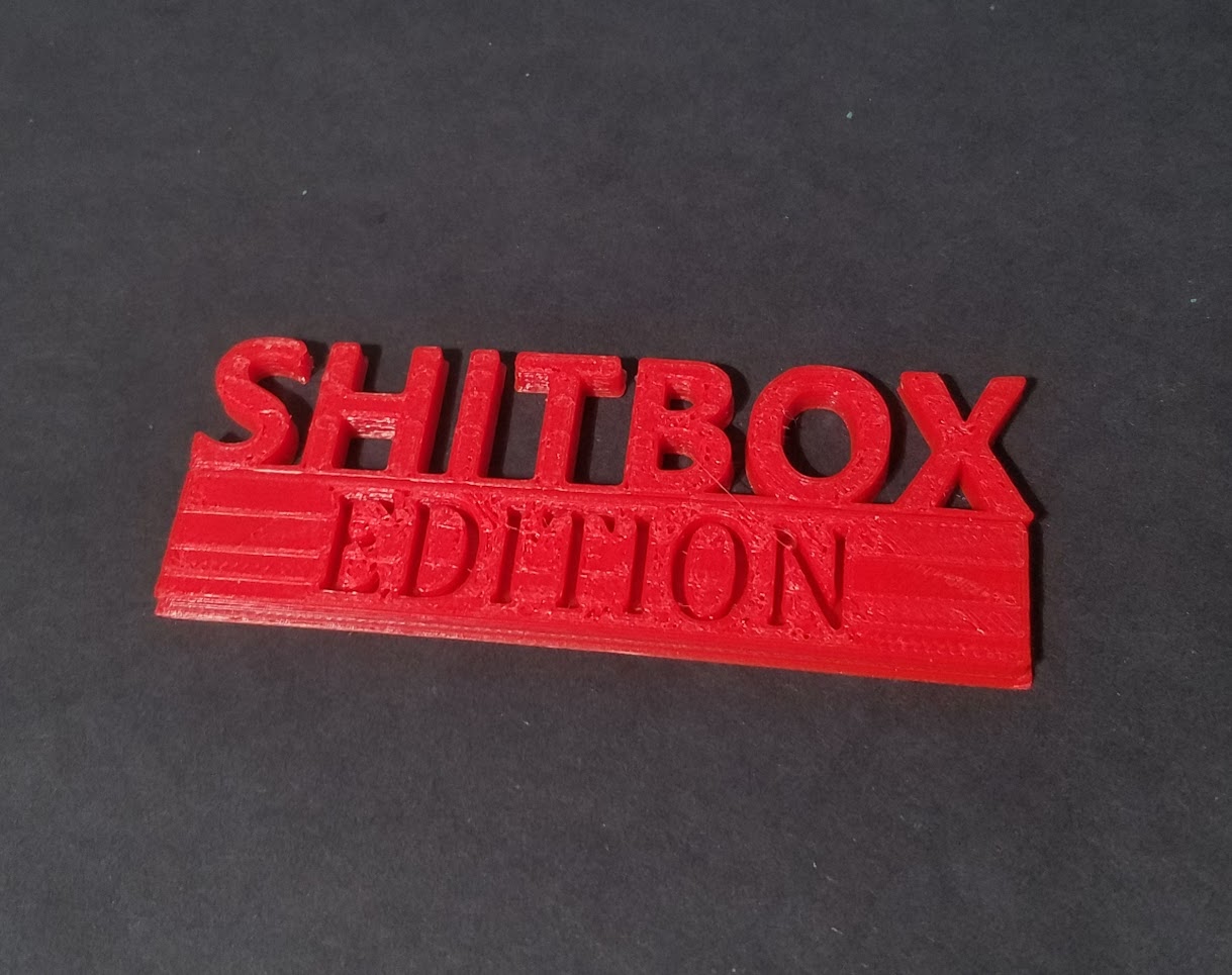 Shitbox Edition Badge - Scaled up with holes for small magnets