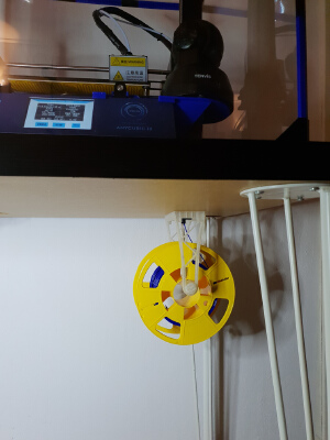 Filament holder hanging on filament entry through Ikea desk | 3d print model