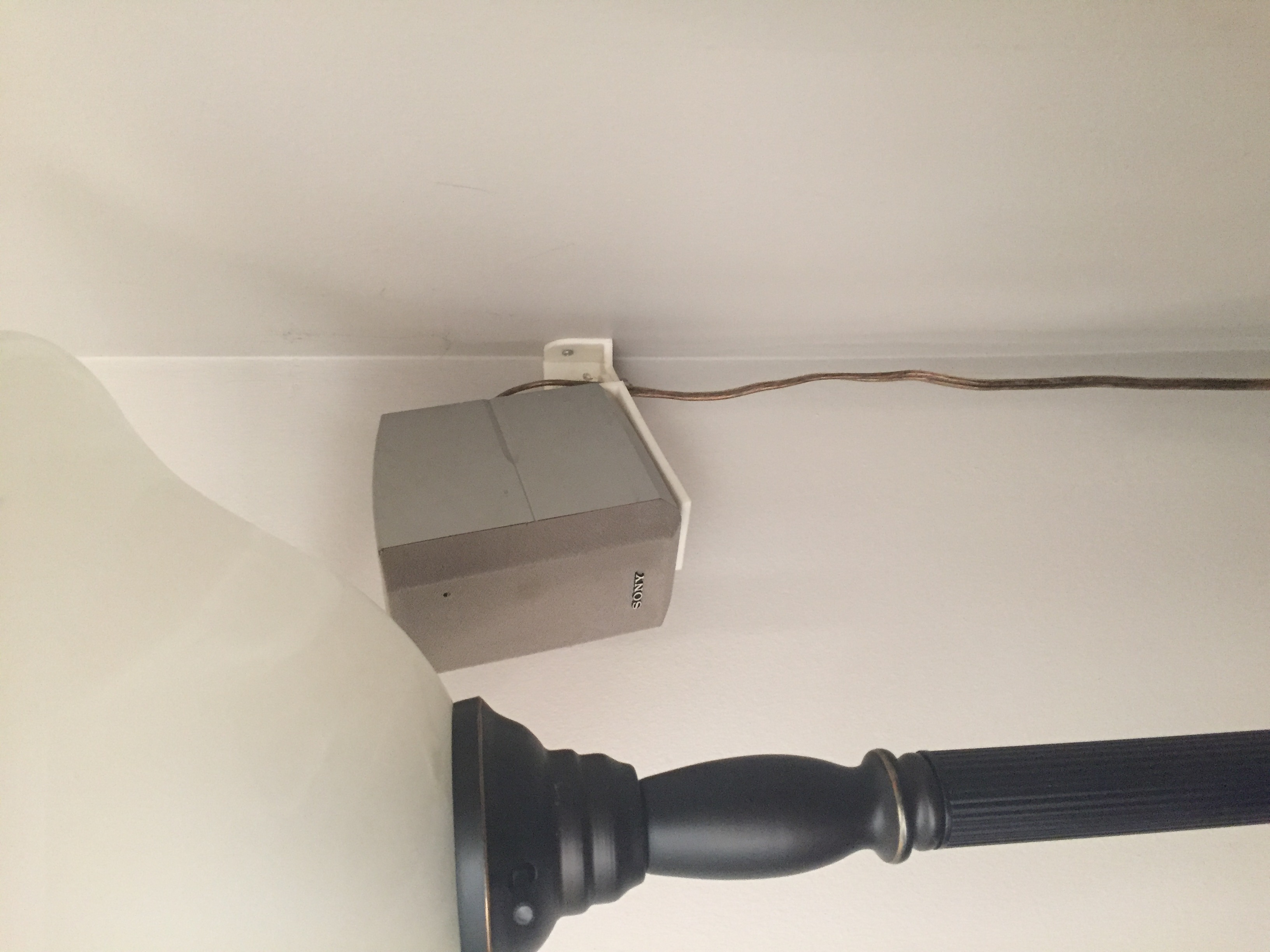 Wall mount for a Sony home theater speaker.