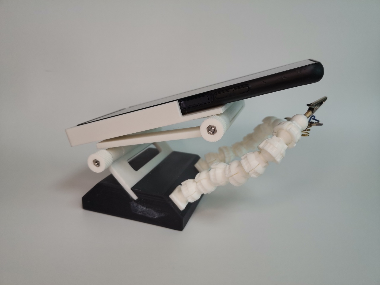 Helping Hands (Third Hands) with Magnifier using a smartphone to magnify